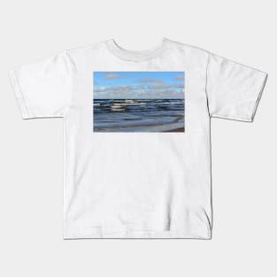 White cumulus clouds in sky over wavy Baltic sea Kids T-Shirt